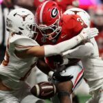 The Texas defense forces a fumble against Georgia during the SEC Championship Game.