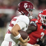 Alabama quarterback Ty Simpson runs with the ball.